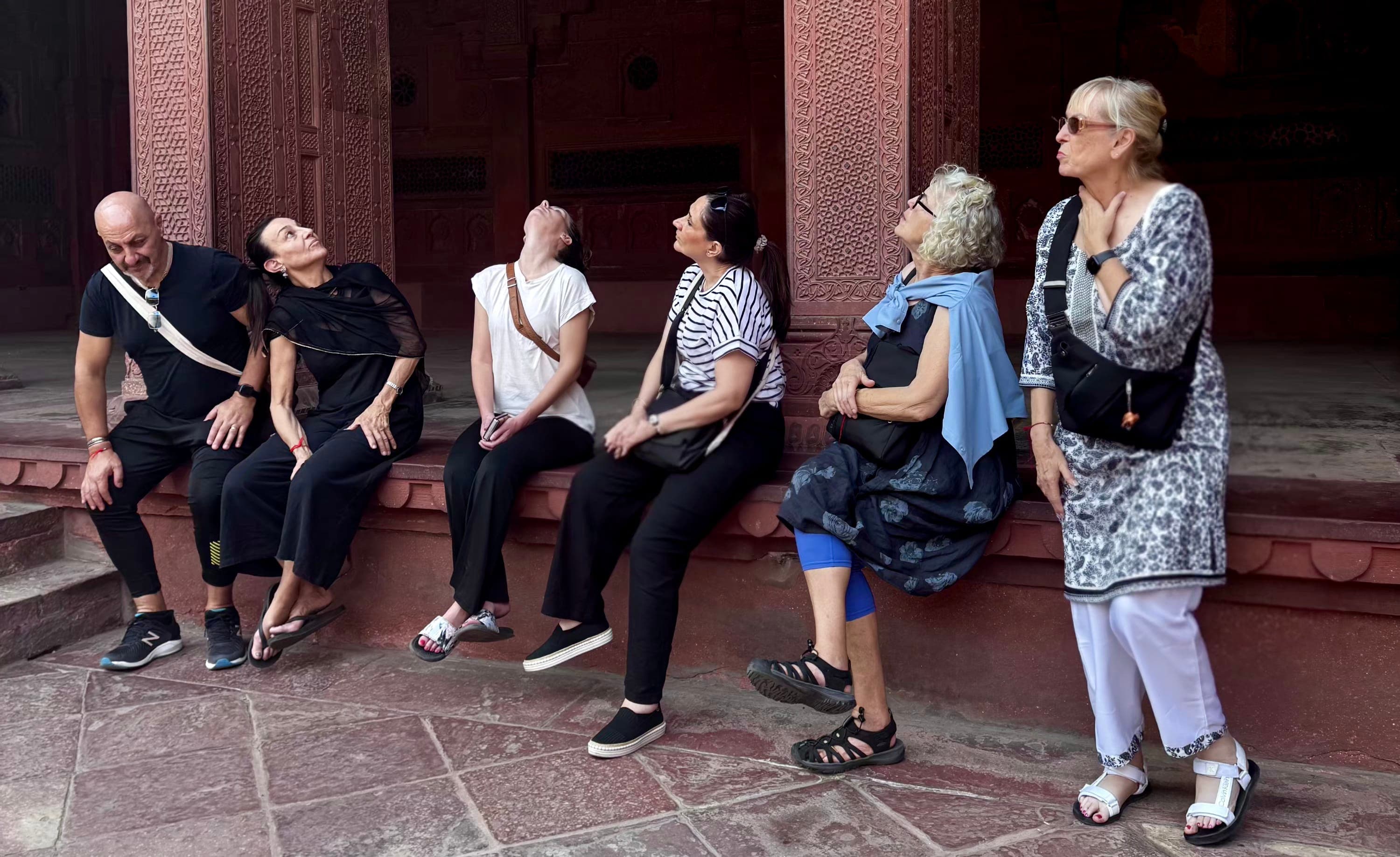 Travellers sharing a meal with local hosts in a Rajasthani village