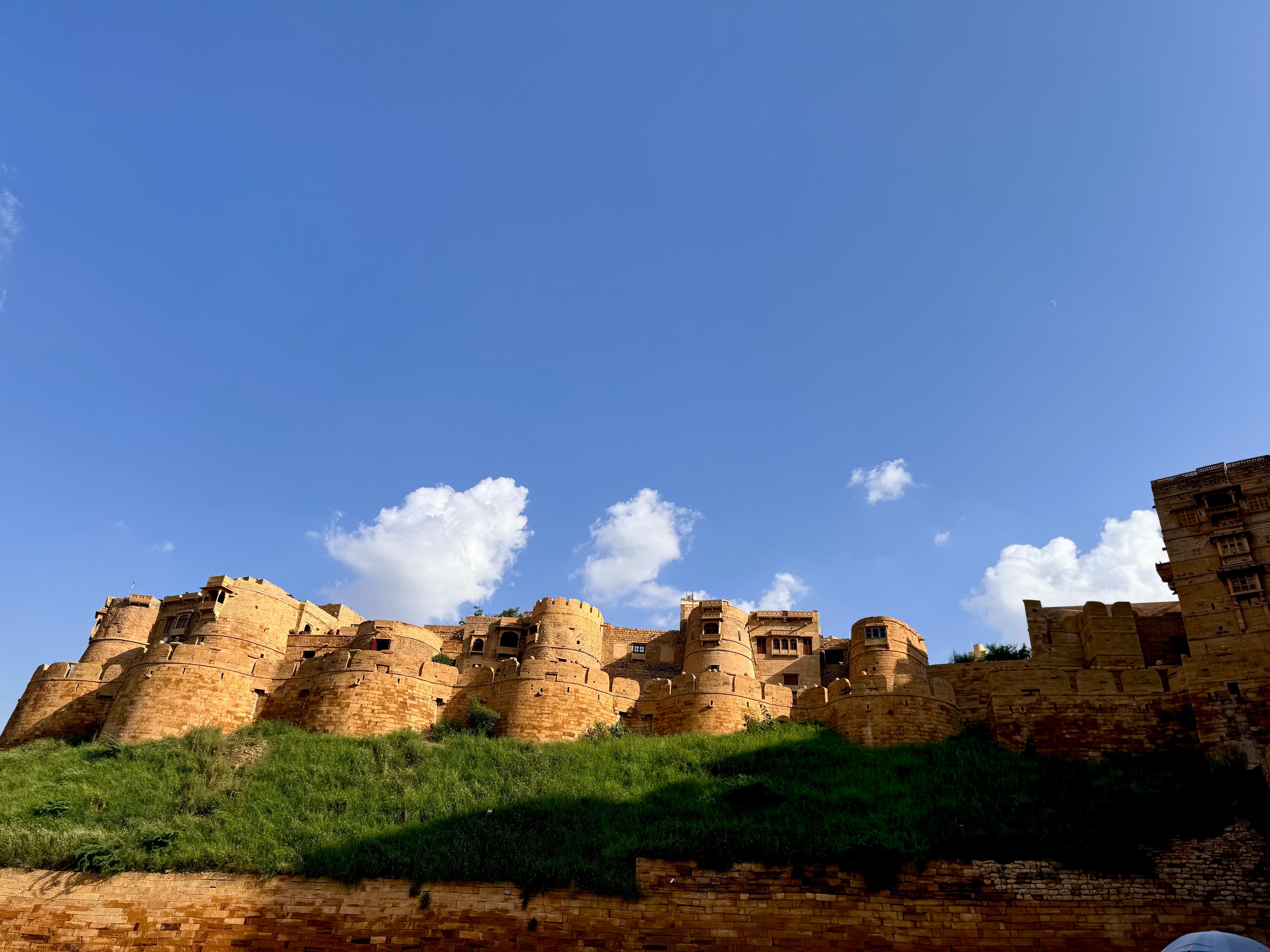 Travellers exploring Jaipur's historic Amber Fort at sunset